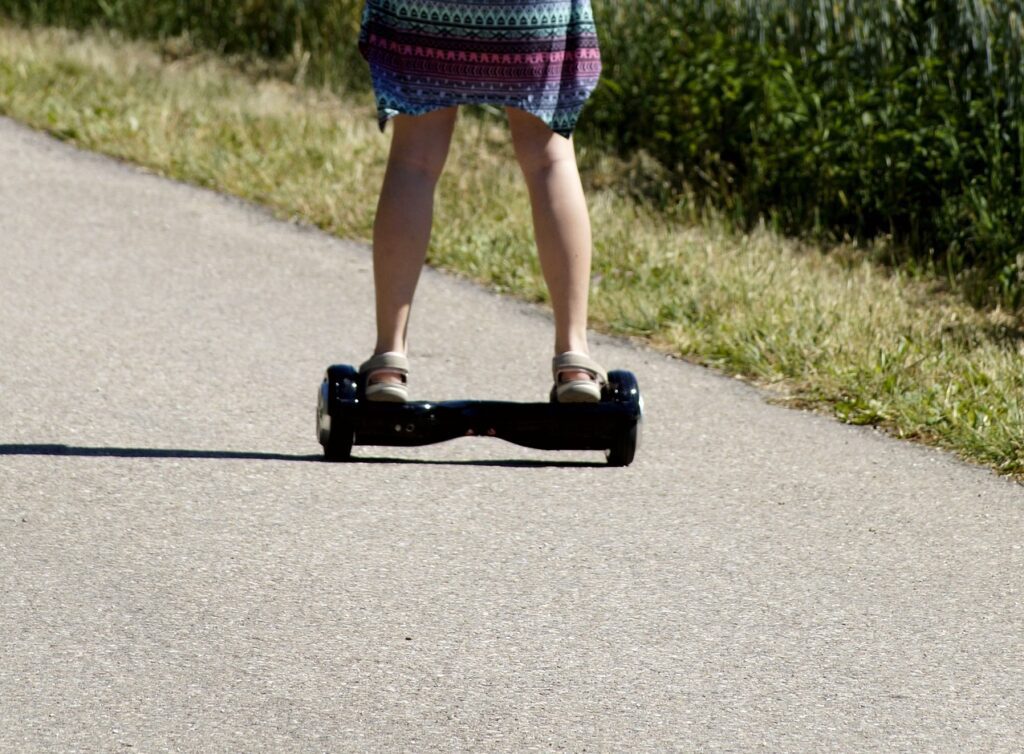 woman riding a Hoverboard along a road